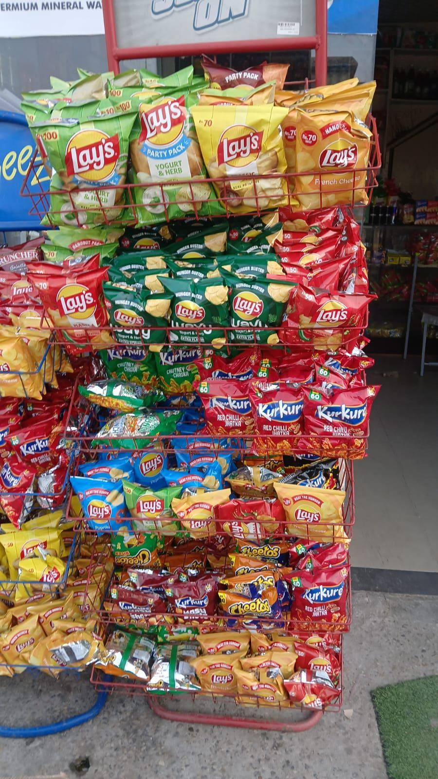Snacks and biscuits rack with chips and crackers at SA Family Mart