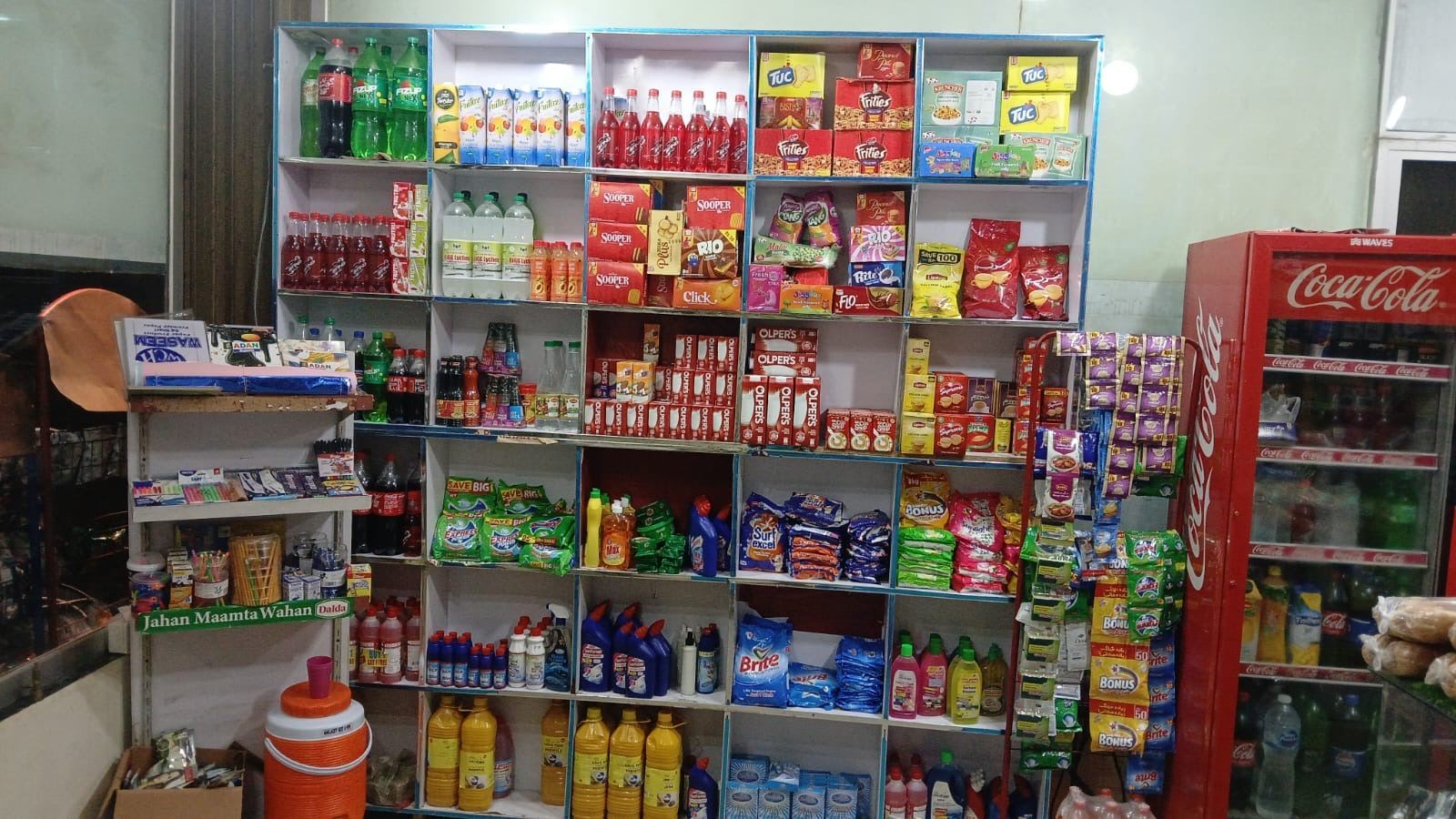 Grocery essentials shelf at SA Family Mart including oils, drinks and packaged food