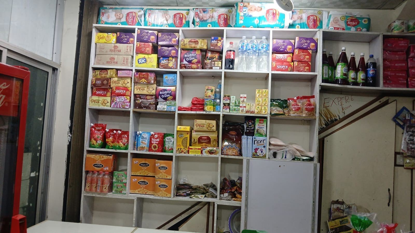 Biscuits and packaged snacks shelf inside SA Family Mart
